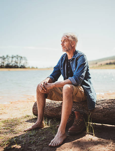 istock Mature man relaxing by a lake 511586488