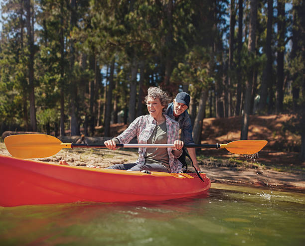 istock Mature couple having fun at the lake with kayak 511586680