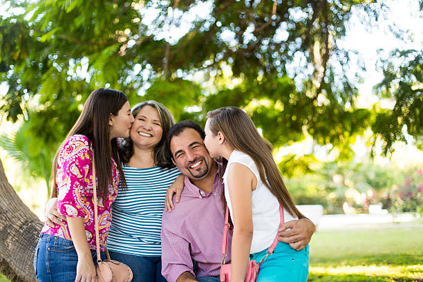 istock Daughters kissing their parents 511586824