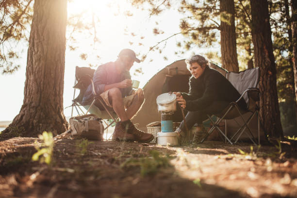 istock Couple cooking food outdoors on a camping trip 511587116