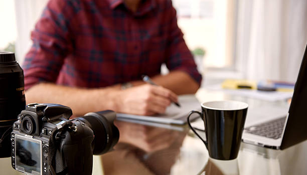 istock Headless crop of a photographer at his home workspace 511589986