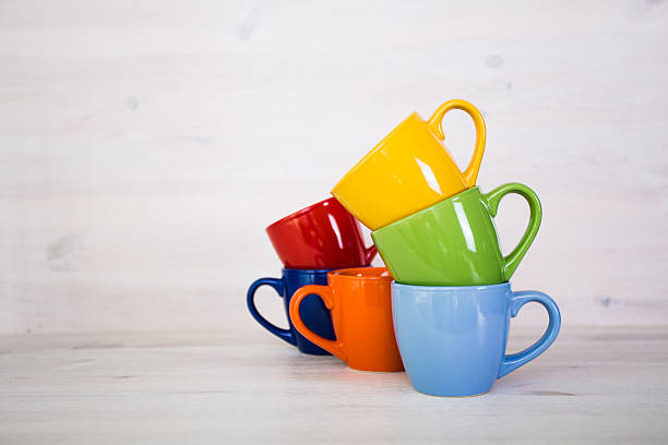 istock stack of colorful coffee cups on a white wooden background 511590192