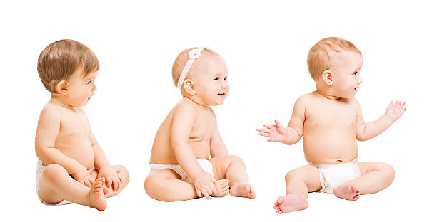 Babies in Diapers Sit , Kids Toddlers, Sitting Boys Girls, White Babies in Diapers Sit over White, Kids Toddlers, Sitting Boys and Girls, One Year Old half dressed girls pictures stock pictures, royalty-free photos & images