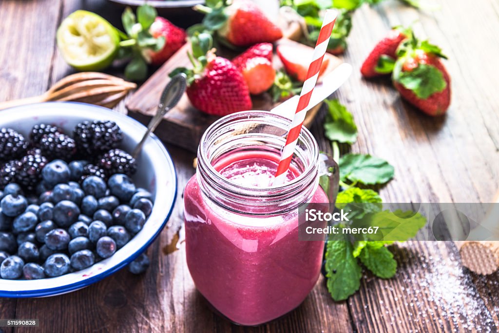 Well being and weight loss concept, berry smoothie. Well being and weight loss concept, berry smoothie.On wooden table with ingredients, from above. Antioxidant Stock Photo