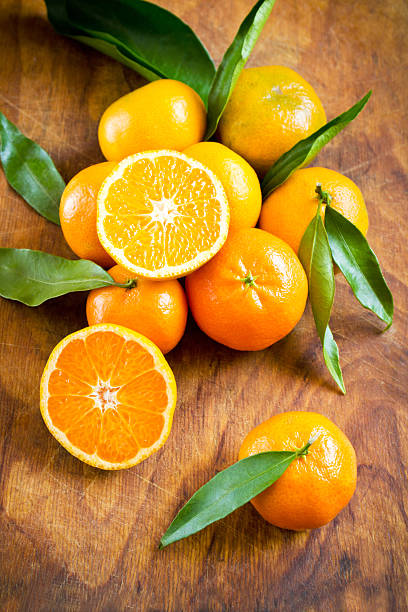 istock Tangerines on a wooden background 511590948