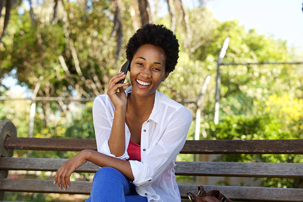 istock Relaxed woman on a park bench and using cell phone 511591998