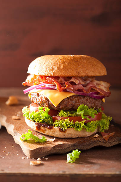 istock bacon cheese burger with beef patty tomato onion 511592362
