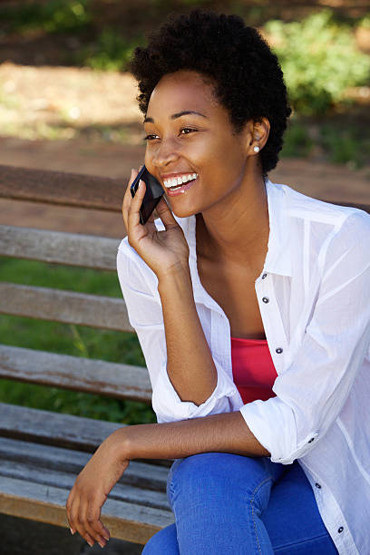 istock Happy young african woman talking on mobile phone 511592482