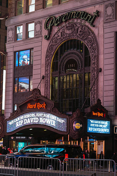 Paramount Building New York, USA - January 12, 2016: The Hard Rock Restaurant in the famous Paramount Building in Times Square with a tribute to David Bowie on the Marquee late into the night. paramount studios stock pictures, royalty-free photos & images