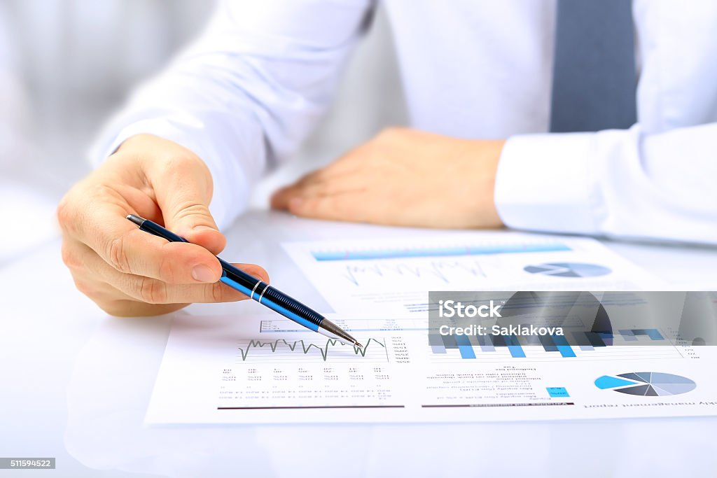 young businessman showing graphs by pen Number Stock Photo