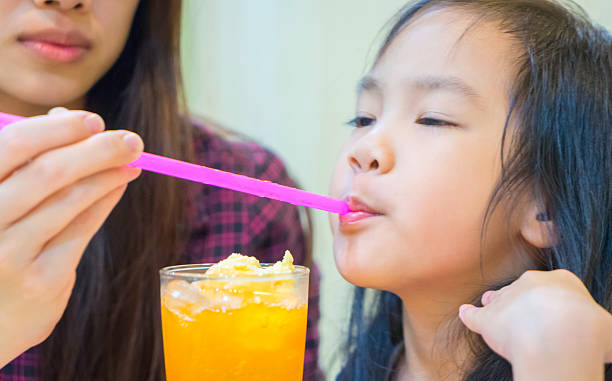 istock Little Asian Girl having juice smoothy 511595910