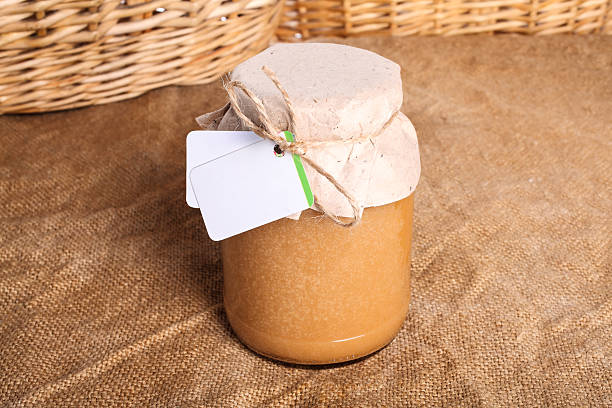 istock Fresh honey in glass jar, cover paper 511596122