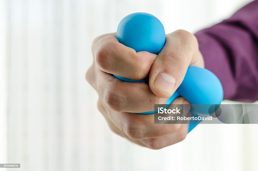 Anti-stress balls in hand Anti-stress balls in hand, according to the window with bright sunlight Exercising Stock Photo