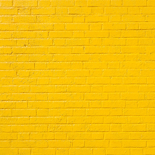 istock square part of yellow painted brick wall 511598852