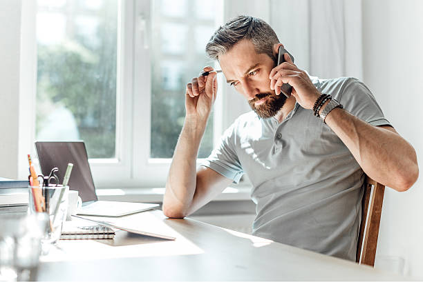istock young bearded business man with smartphone at working desk 511598920