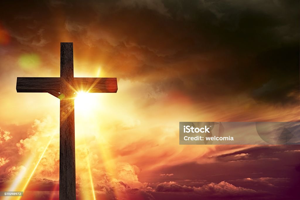Crucifix Blessing Lights Crucifix Blessing Lights Background. Large Wooden Crucifix at Sunset with Right Side Copy Space. Christianity Theme Illustration. Glowing Stock Photo