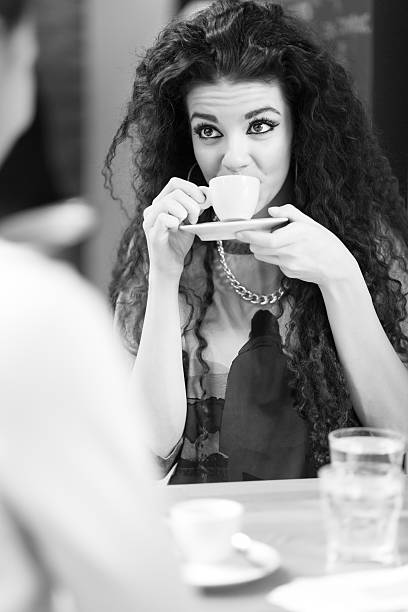 istock Two attractive girlfriends drinking coffee and talking in the ca 511599254