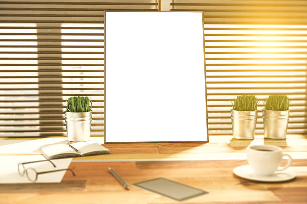 istock Blank picture frame on a wooden desk at sunset 511600720