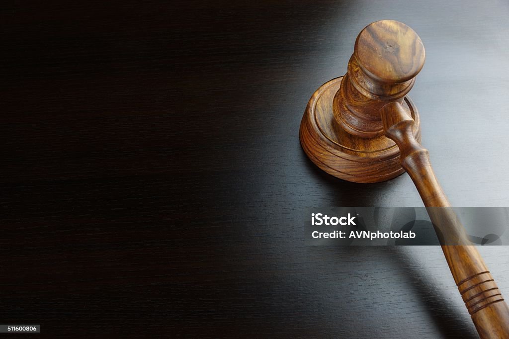 Judges Or Auctioneers Walnut Gavel On The Black Table Judges Or Auctioneers Walnut Gavel And Sound Block On The Empty Black Table In The Back Light. Overhead View. Judge - Law Stock Photo