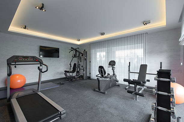 Home gym in luxury villa house Home gym in luxury villa house exercise equipment stock pictures, royalty-free photos & images