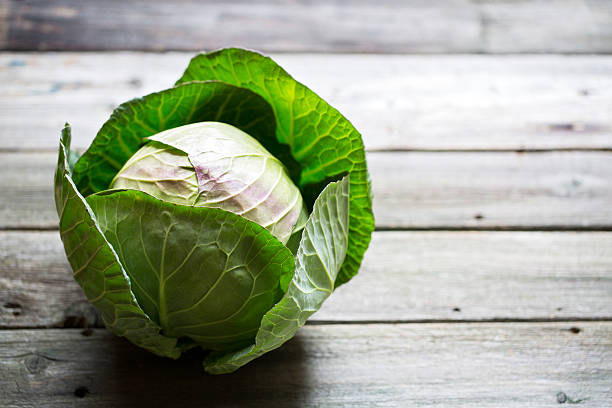istock Fresh green garden cabbage on rustic wooden background 511601218