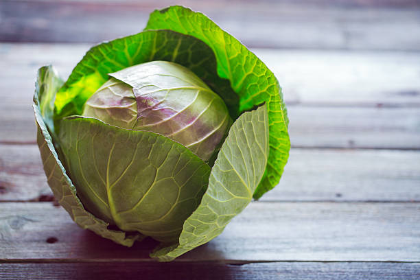 istock Fresh green garden cabbage on rustic wooden background 511601290