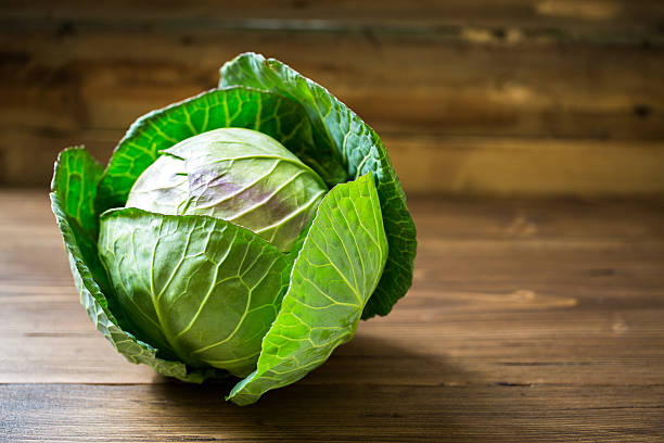 istock Fresh green garden cabbage on rustic wooden background 511601696