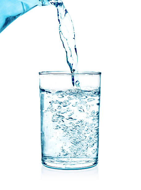 istock pouring water on a glass on white 511601850