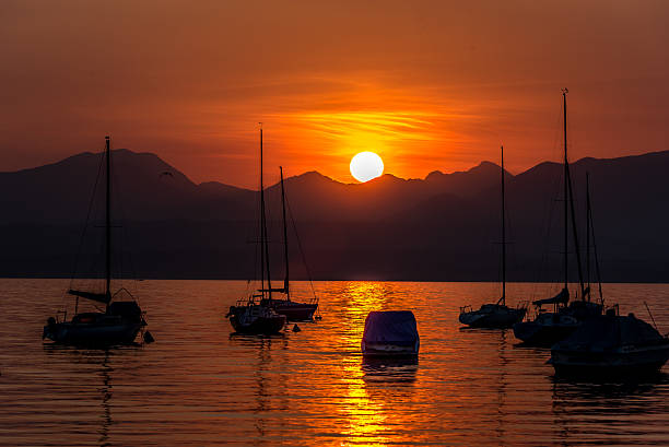 istock Sailing Boats on lake Garda with sunset, Italy 511602092
