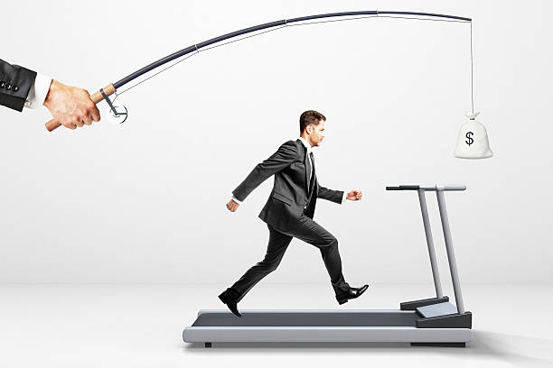 Reach a goal concept with businessman running Reach a goal concept with businessman running on a treadmill for money hunting decoy photos stock pictures, royalty-free photos & images