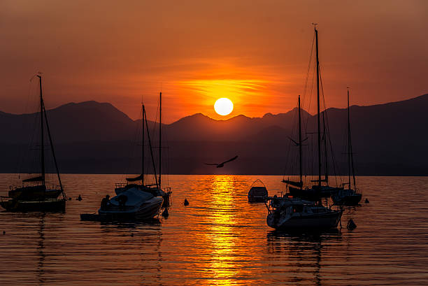 istock Sailing Boats on lake Garda with sunset, Italy 511602574