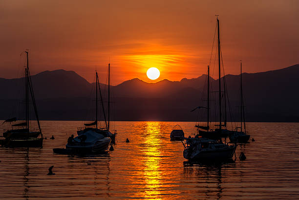 istock Sailing Boats on lake Garda with sunset, Italy 511602854