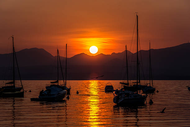 istock Sailing Boats on lake Garda with sunset, Italy 511603096