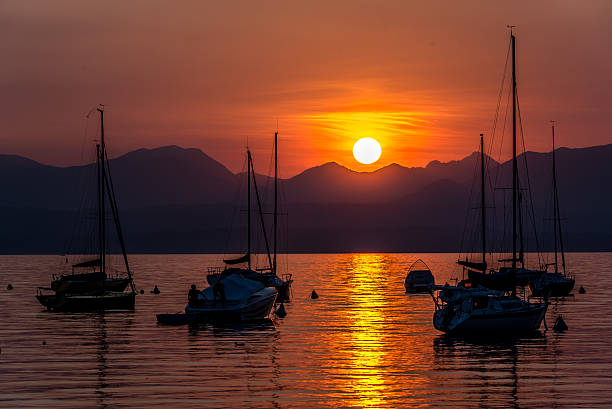 istock Sailing Boats on lake Garda with sunset, Italy 511603348