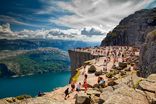 Preikestolen, Norway - July 28, 2014: Pulpit Rock (Preikestolen) is one of the most favourite attractions in Norway. Its a rock 600m above the Lysefjord. During the Summer there are a lot of people there - local people and tourists.