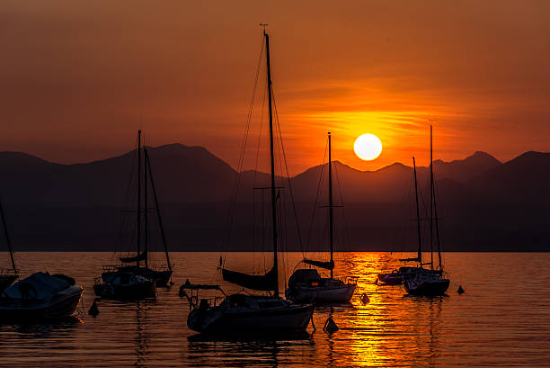 istock Sailing Boats on lake Garda with sunset, Italy 511603998
