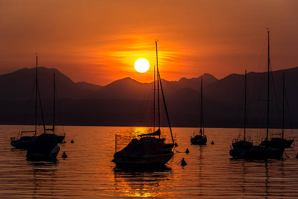 istock Sailing Boats on lake Garda with sunset, Italy 511604530