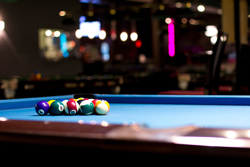 pool balls on a blue table with balls