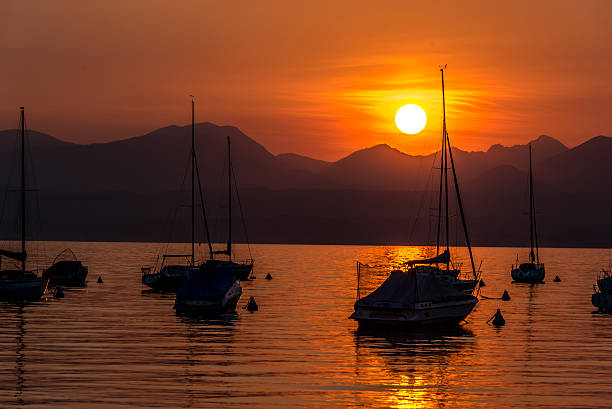 istock Sailing Boats on lake Garda with sunset, Italy 511604754