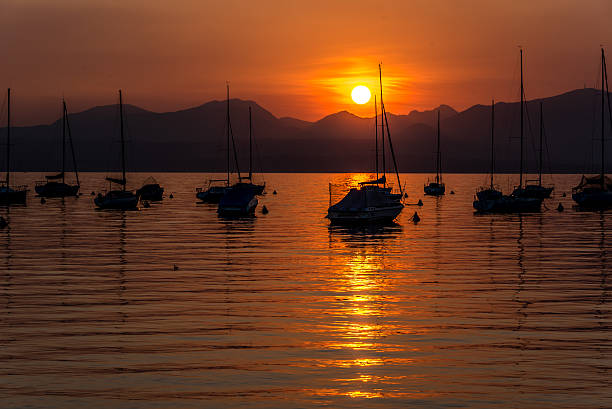 istock Sailing Boats on lake Garda with sunset, Italy 511605042