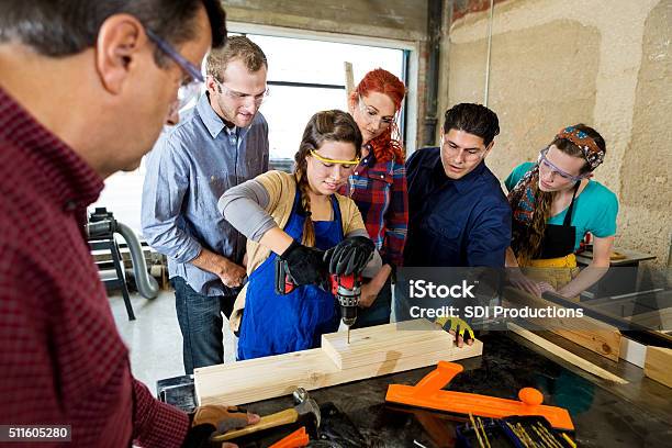 Woman Drills Hole In Board In Makerspace Stock Photo - Download Image Now - Carpenter, Carpentry, Learning