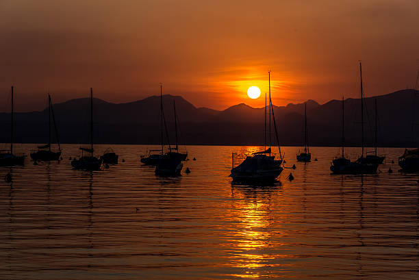 istock Sailing Boats on lake Garda with sunset, Italy 511605308
