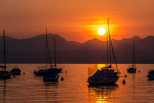 istock Sailing Boats on lake Garda with sunset, Italy 511605822