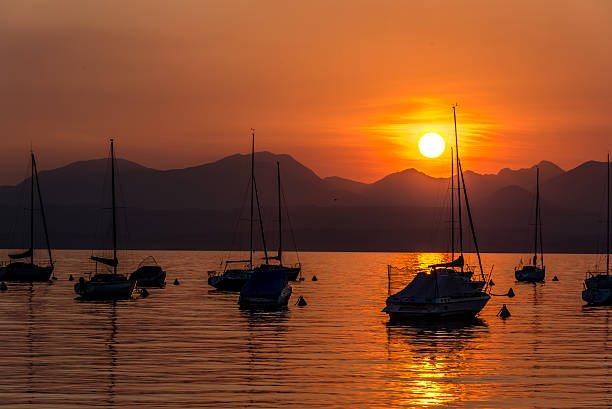 istock Sailing Boats on lake Garda with sunset, Italy 511606080