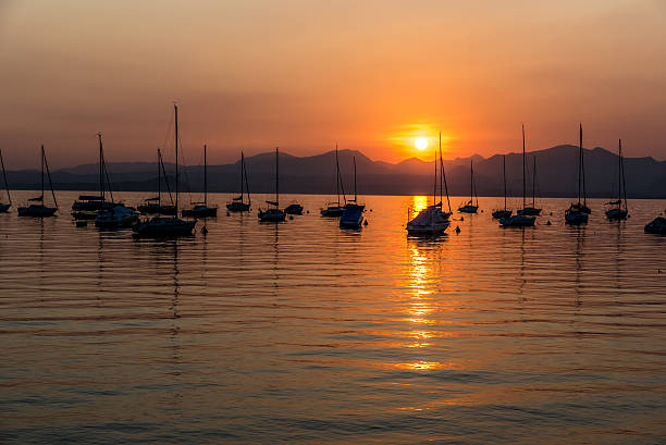 istock Sailing Boats on lake Garda with sunset, Italy 511606388
