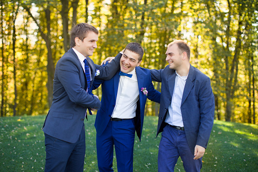 Friends laugh at the wedding of a friend