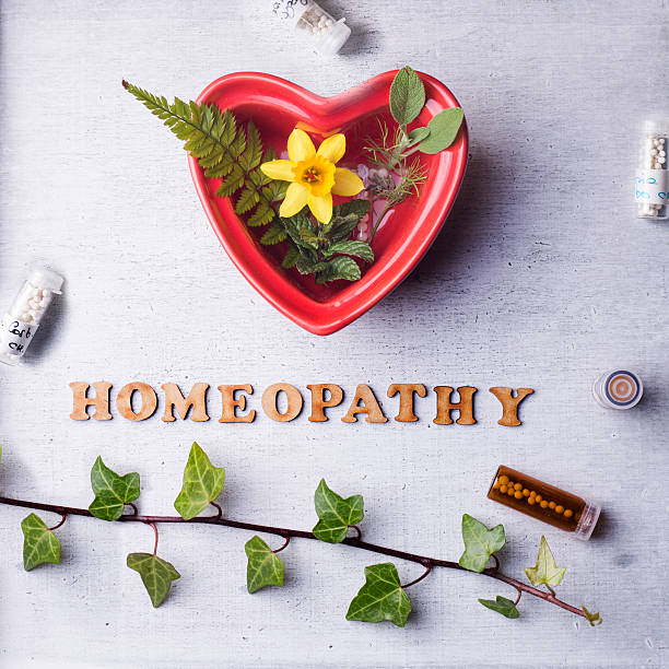 homeopathy globules and bottles Table with written text Homeopathy, homeopathy globules and bottles World Homeopathy Day stock pictures, royalty-free photos & images