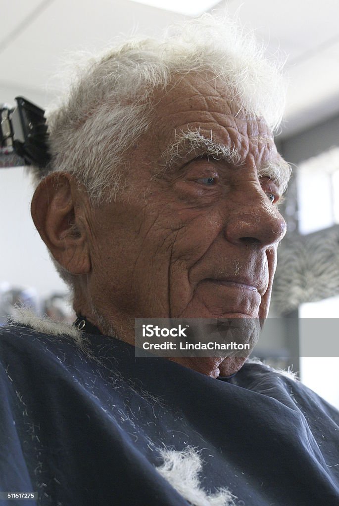 Senior Man Getting Hair Trimmed Senior man with white hair getting hair trimmed. Adult Stock Photo