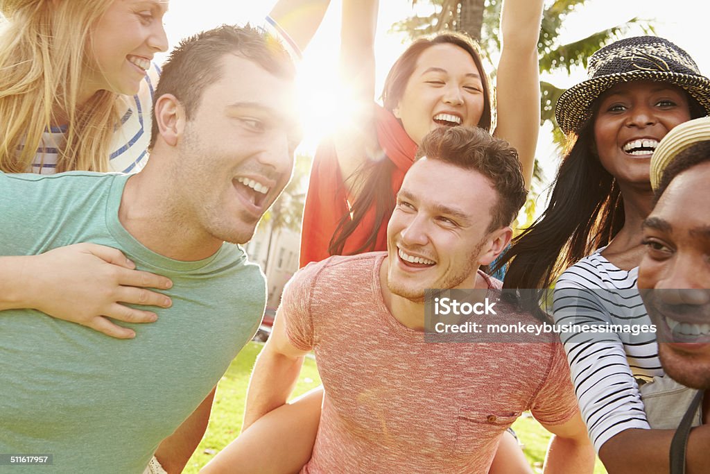 Group Of Friends Having Fun In Park Together Group Of Friends Having Fun In Park Together Smiling 20-29 Years Stock Photo