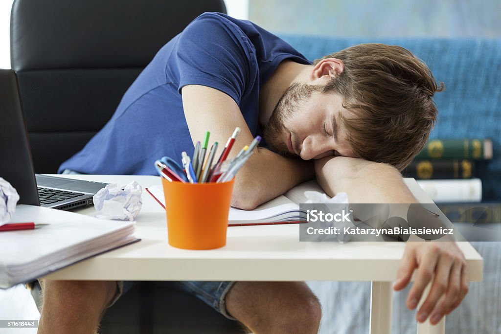 Student sleeps after learning Student sleeps on the desk after learning Adult Stock Photo